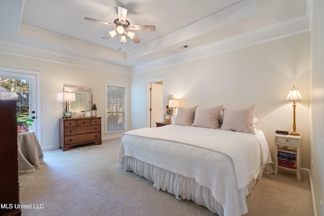 bedroom with ceiling fan, light carpet, access to outside, and a tray ceiling