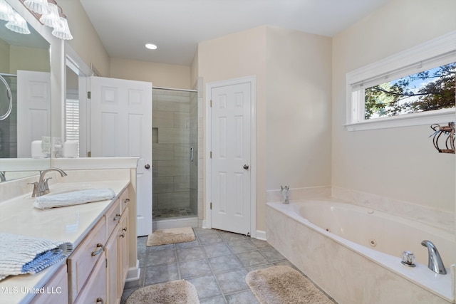 bathroom with vanity and independent shower and bath