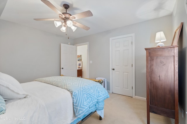 bedroom with ceiling fan and light colored carpet