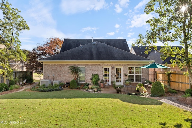 rear view of property with central AC, a yard, and a patio