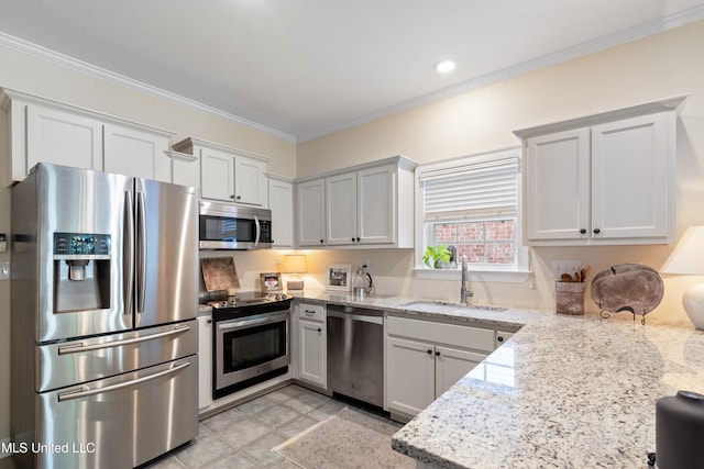 kitchen with light stone countertops, stainless steel appliances, crown molding, sink, and white cabinets