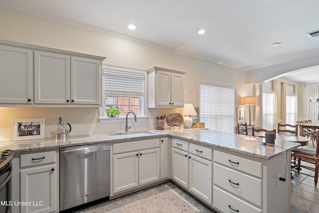 kitchen with white cabinets, sink, stainless steel dishwasher, light stone counters, and kitchen peninsula