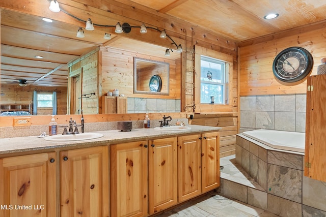 927 Abe Chapel Rd, Como, MS 38619 - bathroom with wood walls, double vanity, tiled bath, wooden ceiling, and recessed lighting