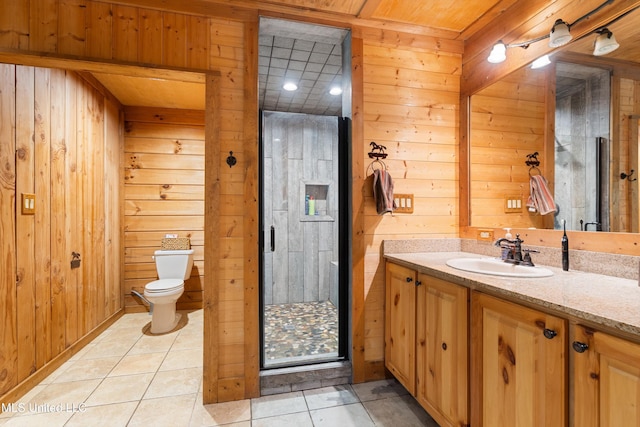927 Abe Chapel Rd, Como, MS 38619 - bathroom with wood walls, vanity, tile patterned flooring, and toilet