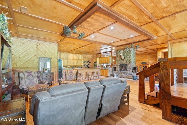 927 Abe Chapel Rd, Como, MS 38619 - living room with wooden walls, light wood-type flooring, wooden ceiling, and a stone fireplace
