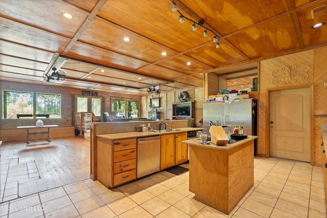 927 Abe Chapel Rd, Como, MS 38619 - kitchen with appliances with stainless steel finishes, wood ceiling, a kitchen island with sink, open floor plan, and wooden walls