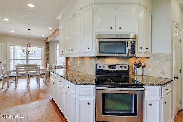 kitchen featuring white cabinetry, appliances with stainless steel finishes, and light wood finished floors