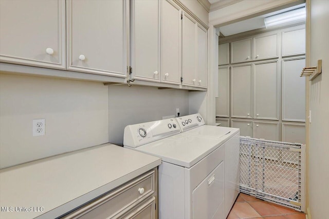 clothes washing area featuring light tile patterned floors, cabinet space, and independent washer and dryer