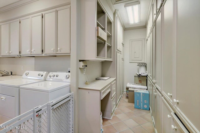 laundry room featuring light tile patterned floors, cabinet space, and washing machine and clothes dryer