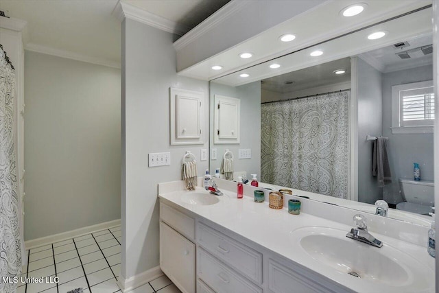 bathroom featuring tile patterned floors, crown molding, baseboards, and a sink