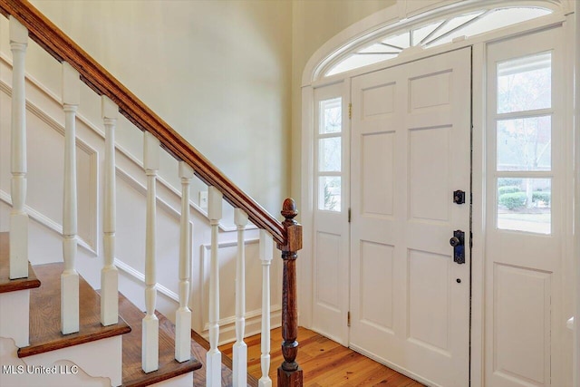 foyer featuring stairway, a healthy amount of sunlight, and light wood finished floors