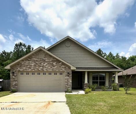 14816 Canal Crossing Blvd, Gulfport, MS 39503 - view of front of home with a garage, concrete driveway, a front yard, and brick siding
