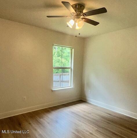14816 Canal Crossing Blvd, Gulfport, MS 39503 - spare room with dark wood-style flooring and a ceiling fan