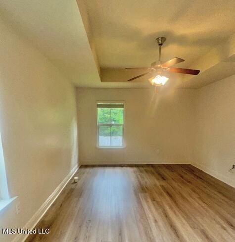 14816 Canal Crossing Blvd, Gulfport, MS 39503 - empty room featuring wood finished floors, ceiling fan, and a raised ceiling