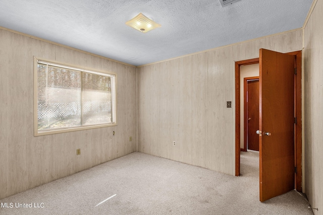 carpeted spare room featuring a textured ceiling