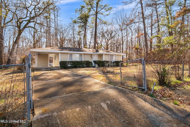 219 E Jackson St, Ridgeland, MS 39157 - mid-century home featuring a gate, a carport, aphalt driveway, and fence