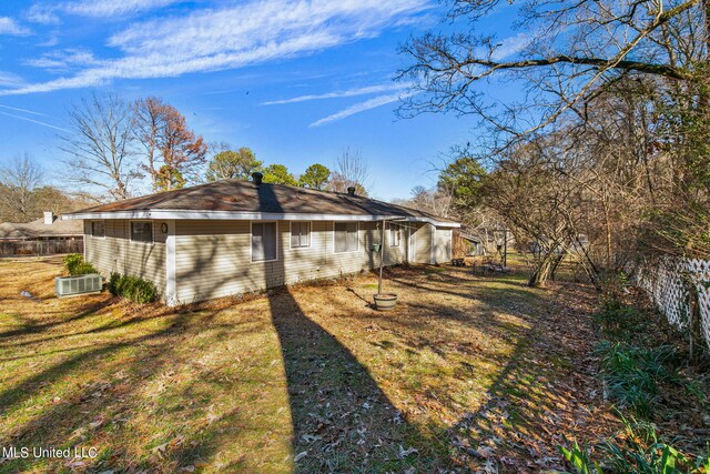219 E Jackson St, Ridgeland, MS 39157 - back of house with a lawn, a chimney, and fence