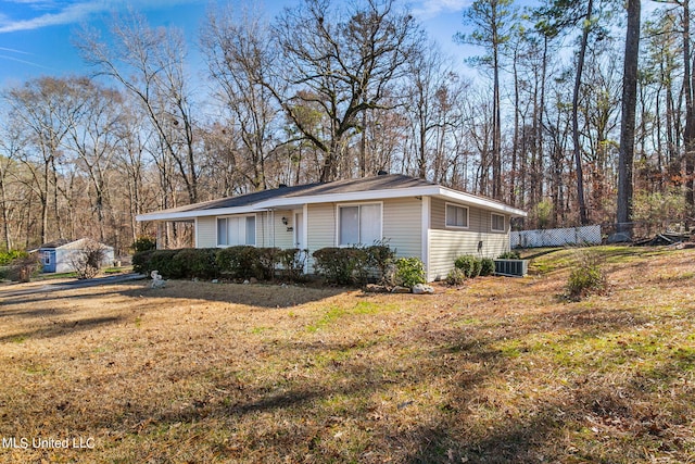 view of home's exterior with central AC and a lawn