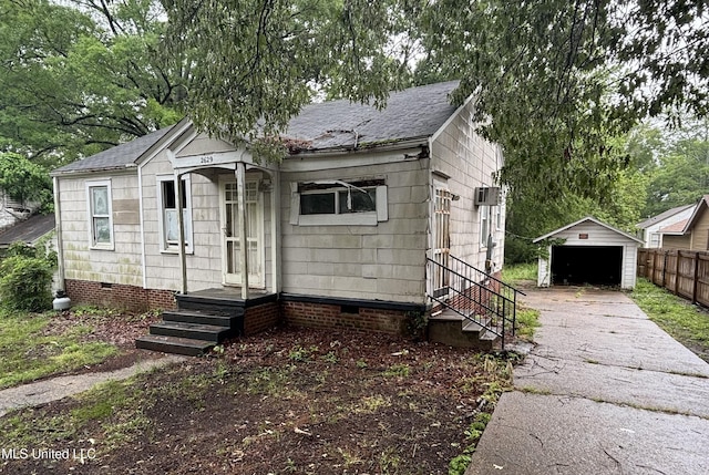 bungalow-style house with crawl space, a garage, an outdoor structure, and fence