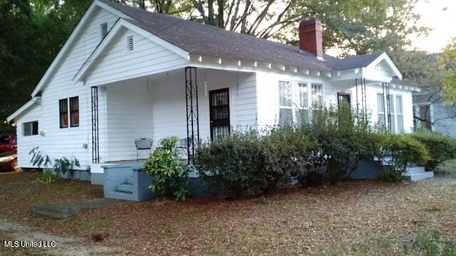 109 Hightower St, Sardis, MS 38666 - view of front of house featuring a chimney and covered porch