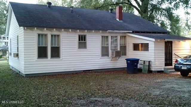 109 Hightower St, Sardis, MS 38666 - back of house featuring a shingled roof, cooling unit, and a chimney