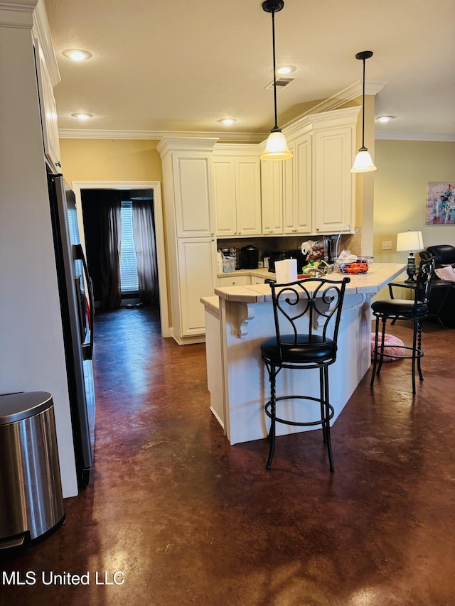 8 Audubon Pl, Natchez, MS 39120 - kitchen with stainless steel fridge, a peninsula, concrete floors, and crown molding