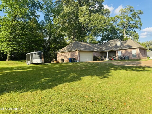 8 Audubon Pl, Natchez, MS 39120 - view of front of home featuring a garage, brick siding, and a front lawn
