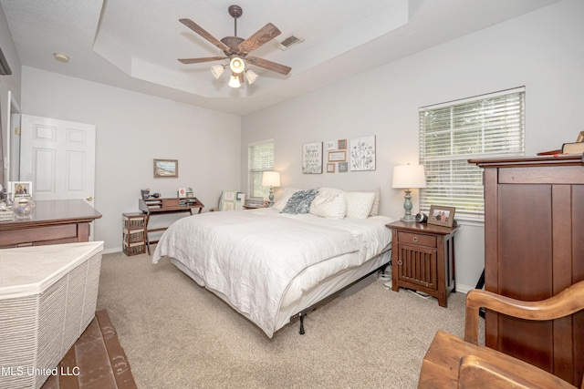 13109 Little Bluff Dr, Vancleave, MS 39565 - bedroom featuring light carpet, a tray ceiling, and ceiling fan