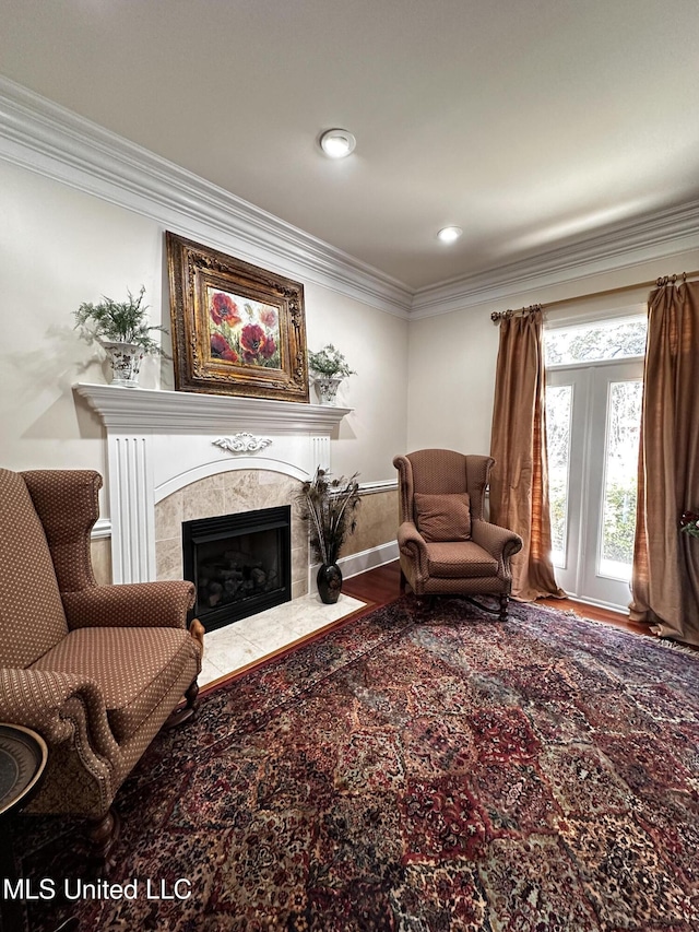 interior space with ornamental molding, a high end fireplace, and hardwood / wood-style floors