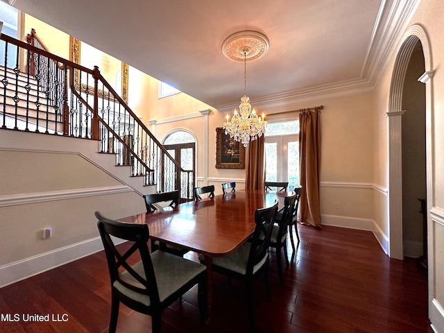 dining space with an inviting chandelier, dark hardwood / wood-style flooring, decorative columns, and crown molding