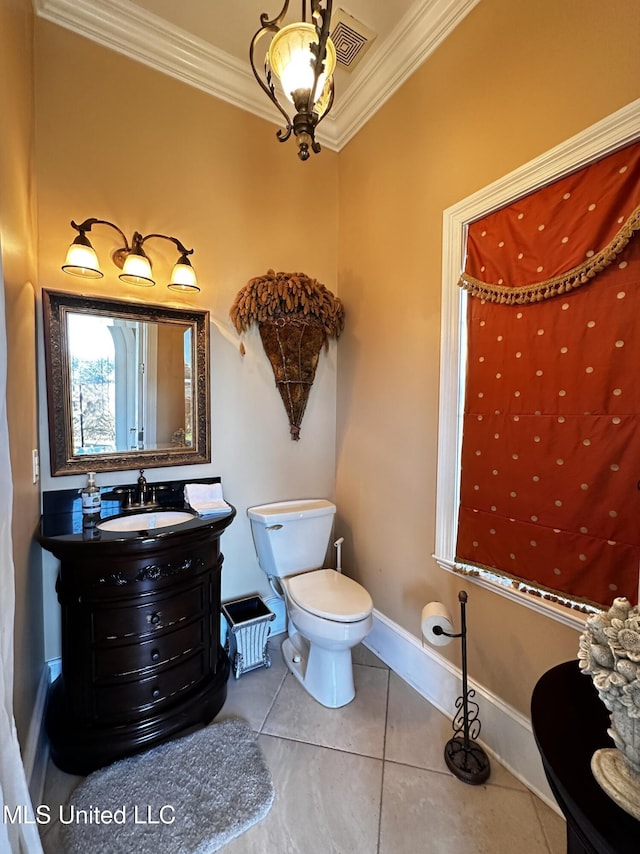 bathroom featuring vanity, crown molding, tile patterned floors, and toilet