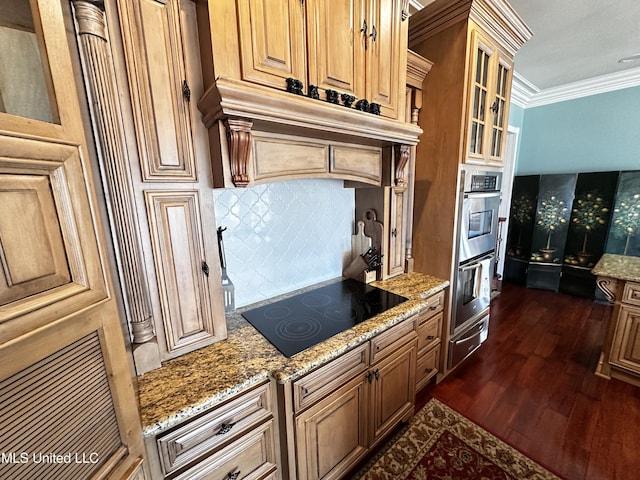 kitchen featuring black electric cooktop, crown molding, dark wood-type flooring, and light stone counters