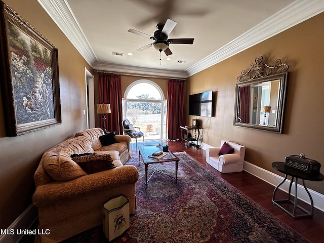 living room with dark wood-type flooring, ornamental molding, and ceiling fan