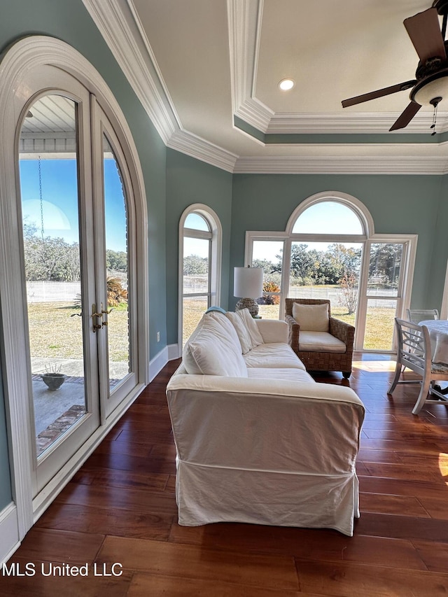 bedroom with ornamental molding, dark hardwood / wood-style floors, access to exterior, and a tray ceiling