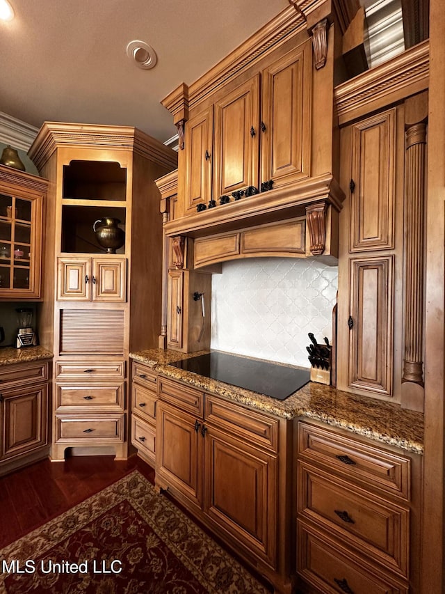 kitchen featuring black electric cooktop, stone counters, dark wood-type flooring, and backsplash