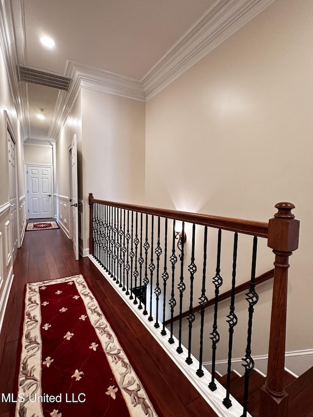 corridor with ornamental molding and dark hardwood / wood-style floors