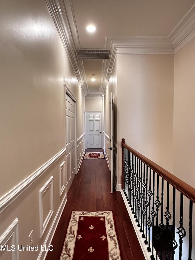 hallway with dark hardwood / wood-style flooring and crown molding