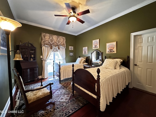 bedroom featuring dark wood-type flooring, ornamental molding, and ceiling fan