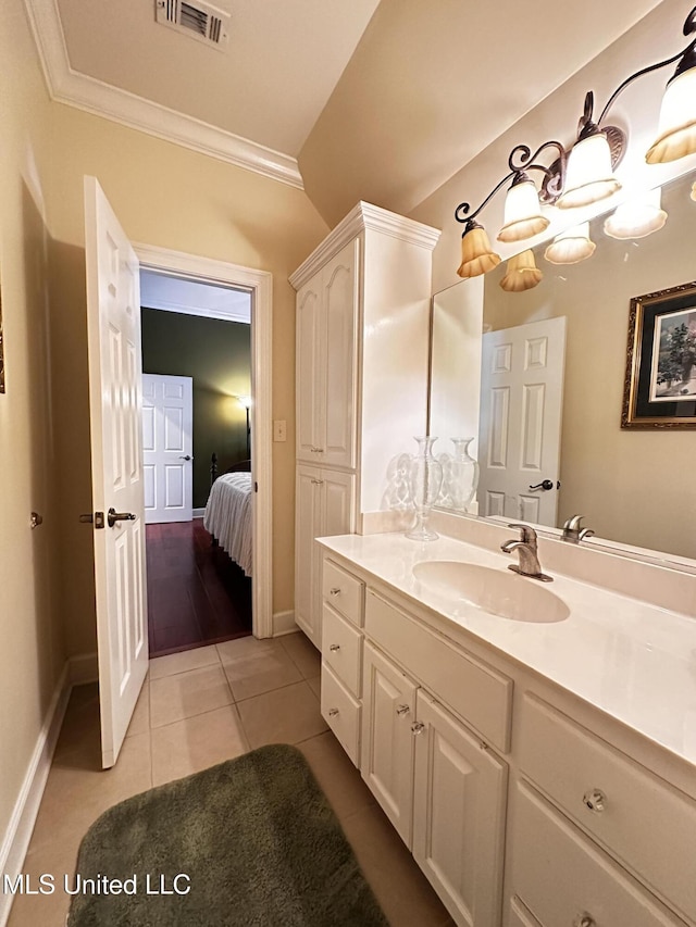 bathroom with vanity, tile patterned floors, and crown molding