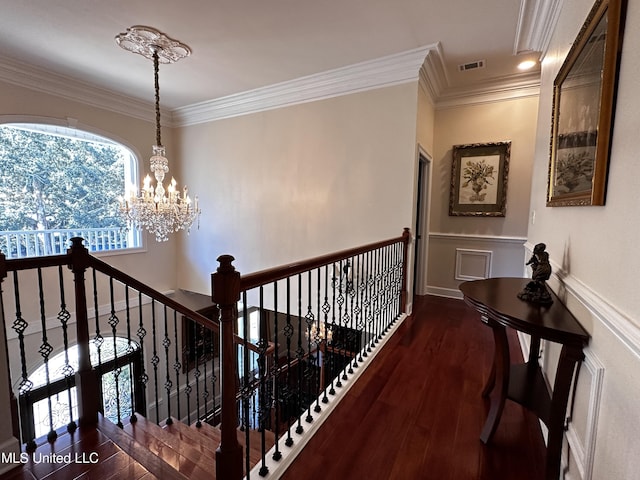 hallway featuring crown molding, dark hardwood / wood-style floors, and a chandelier