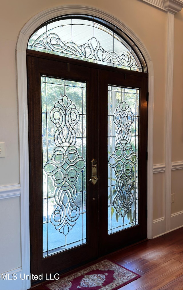 entrance foyer with french doors and hardwood / wood-style floors