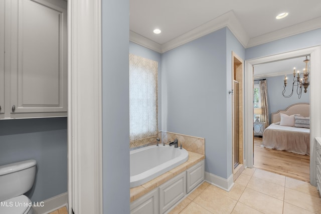 bathroom with independent shower and bath, toilet, tile patterned floors, a notable chandelier, and ornamental molding