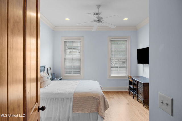 bedroom with ceiling fan, ornamental molding, multiple windows, and light wood-type flooring