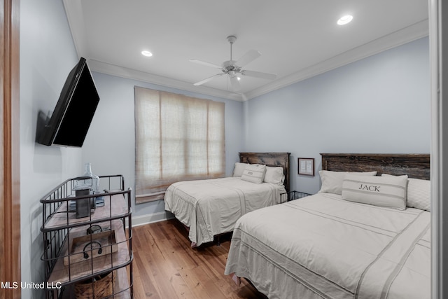 bedroom with ceiling fan, crown molding, and wood-type flooring