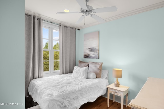 bedroom with hardwood / wood-style floors, crown molding, and ceiling fan