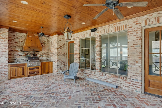 view of patio with exterior kitchen, a grill, and ceiling fan