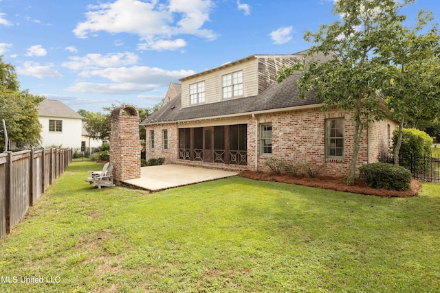 rear view of property with a yard and a patio