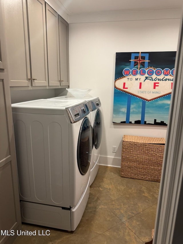 clothes washing area featuring cabinet space, separate washer and dryer, and baseboards