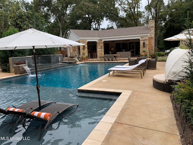 outdoor pool featuring outdoor lounge area, an outdoor structure, a patio area, and an exterior structure