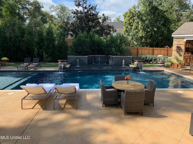 view of pool featuring a patio, outdoor dining area, fence, and a fenced in pool